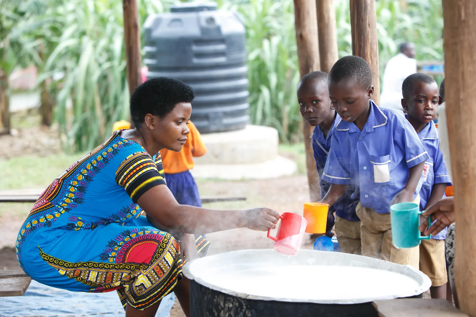 School children being served milk mixed with maize flour 