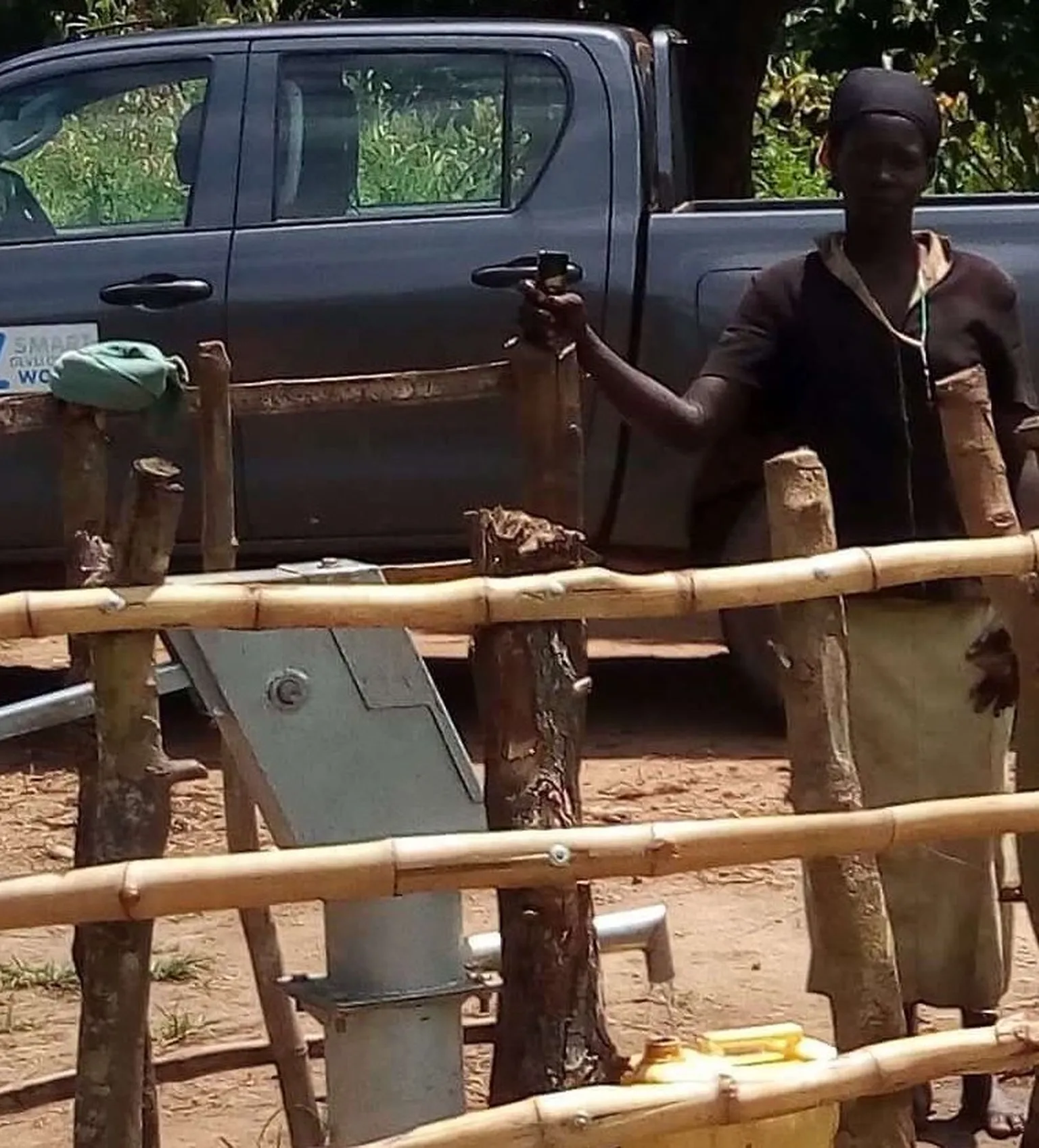 Female Caretaker inspects water source