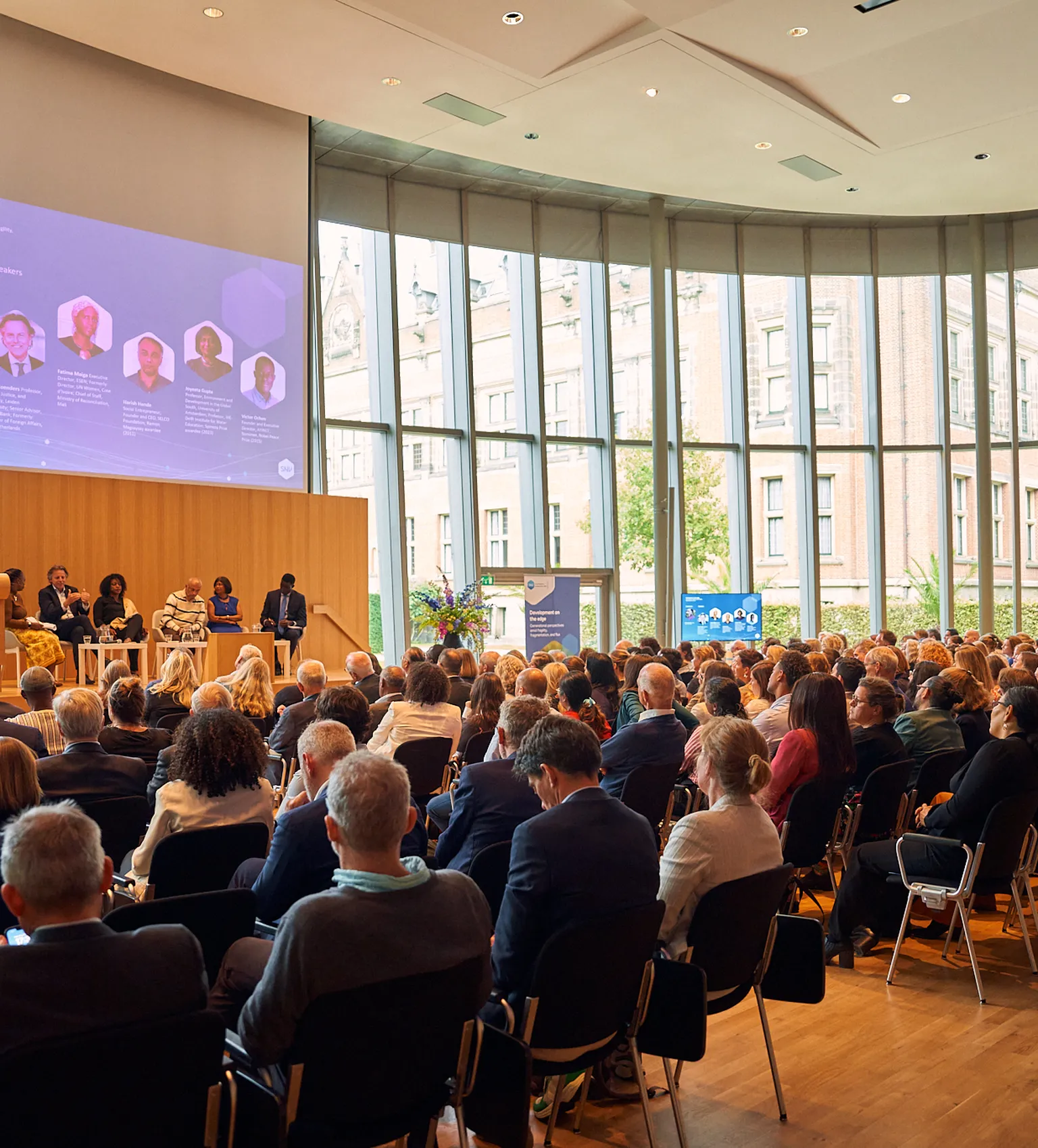 Attendees of the SNV60 event speaking to each other