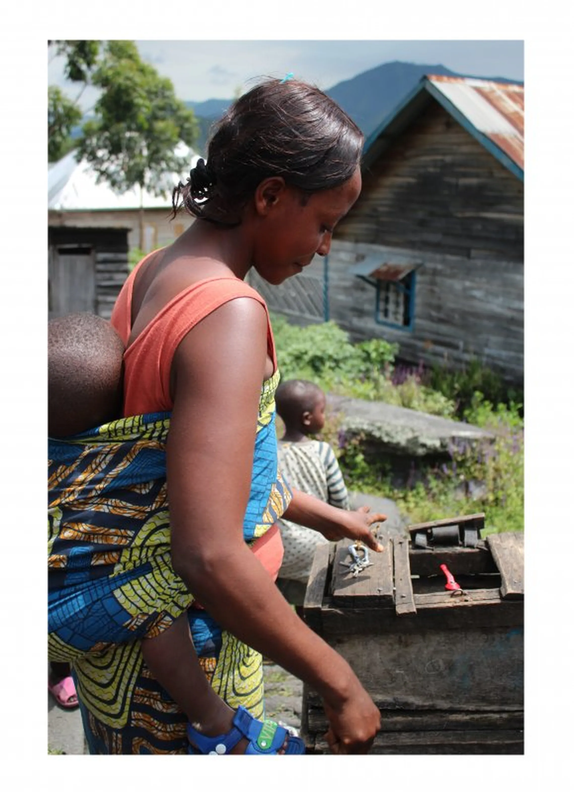 Ms Kahindo Byamungu, Sake ASUREP worker, opens water point at scheduled times