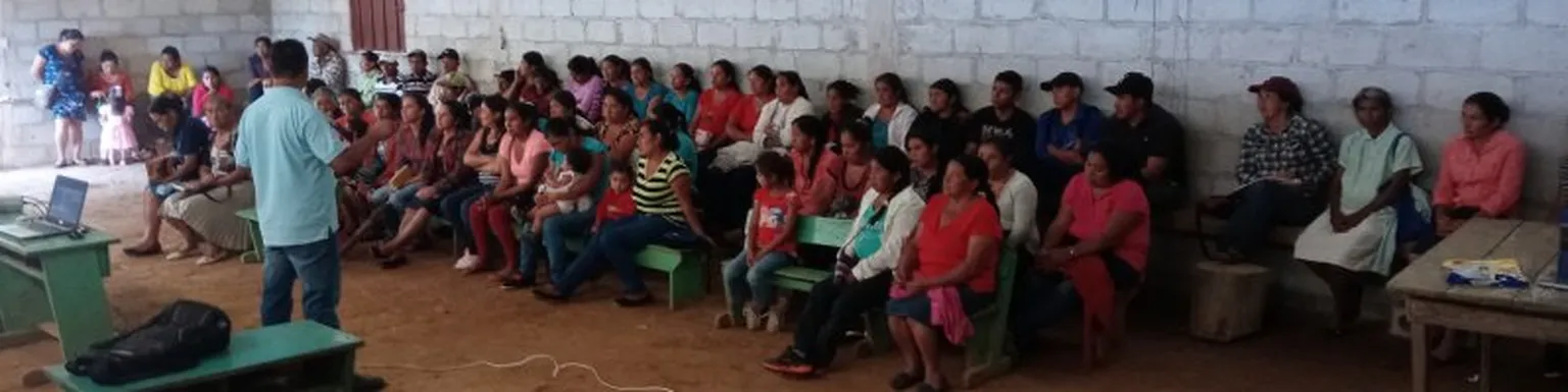 People being spoken to by a man in a room.