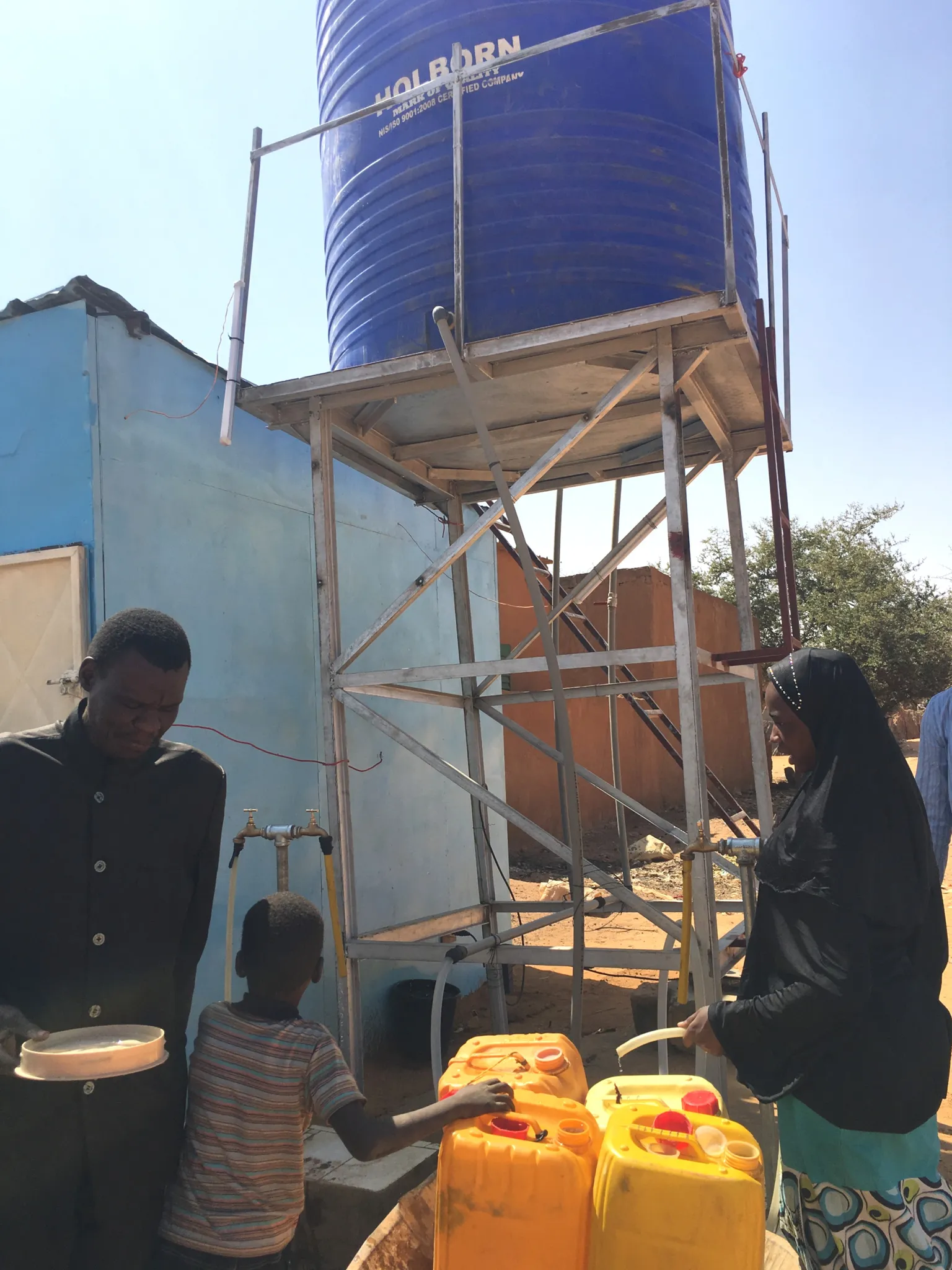 Seno residents filling up water containers at the GIMAFOR solar water pump