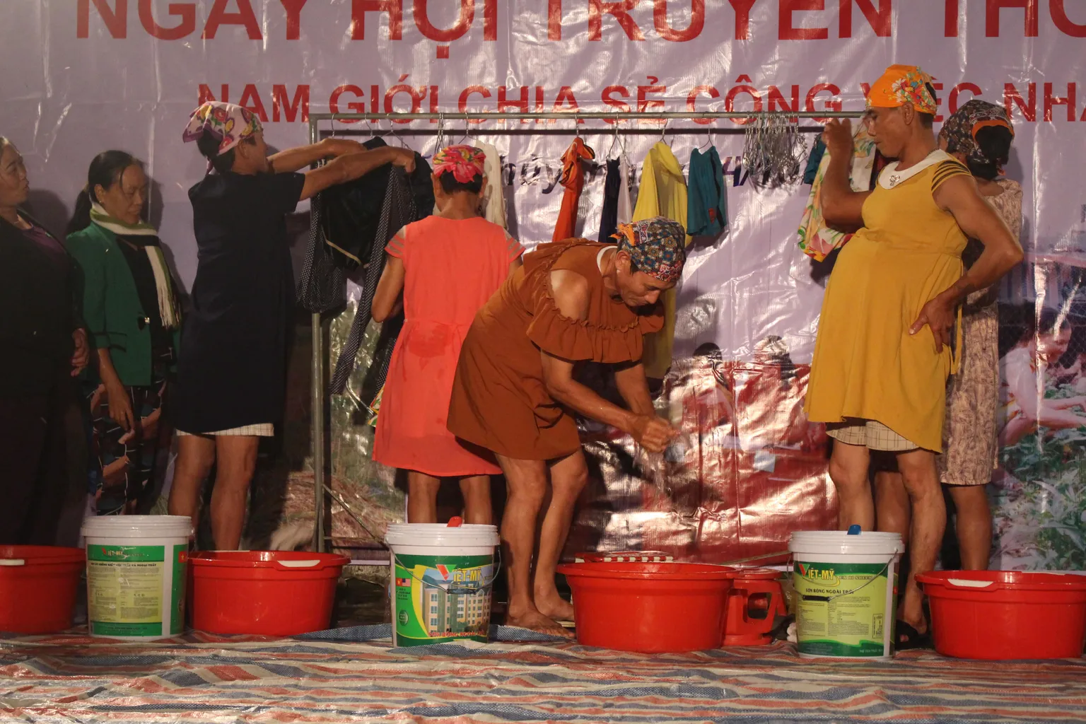 Men washing clothes during commune festival in Quang Binh