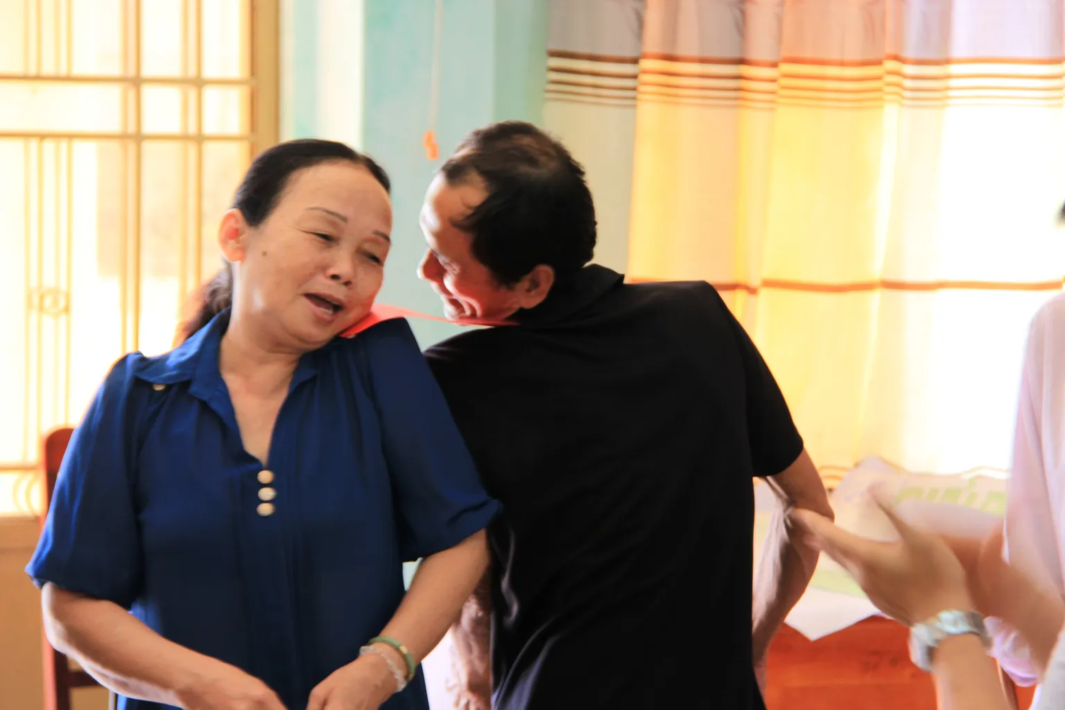 Men and women playing a game during household dialogue in Ninh Thuan