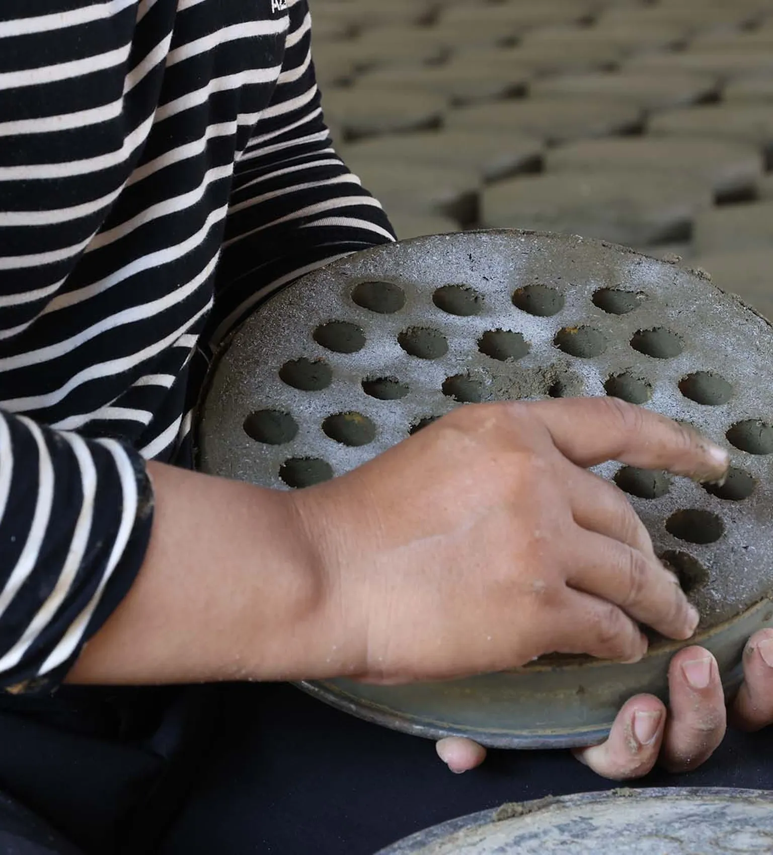 woman producing cookstoves