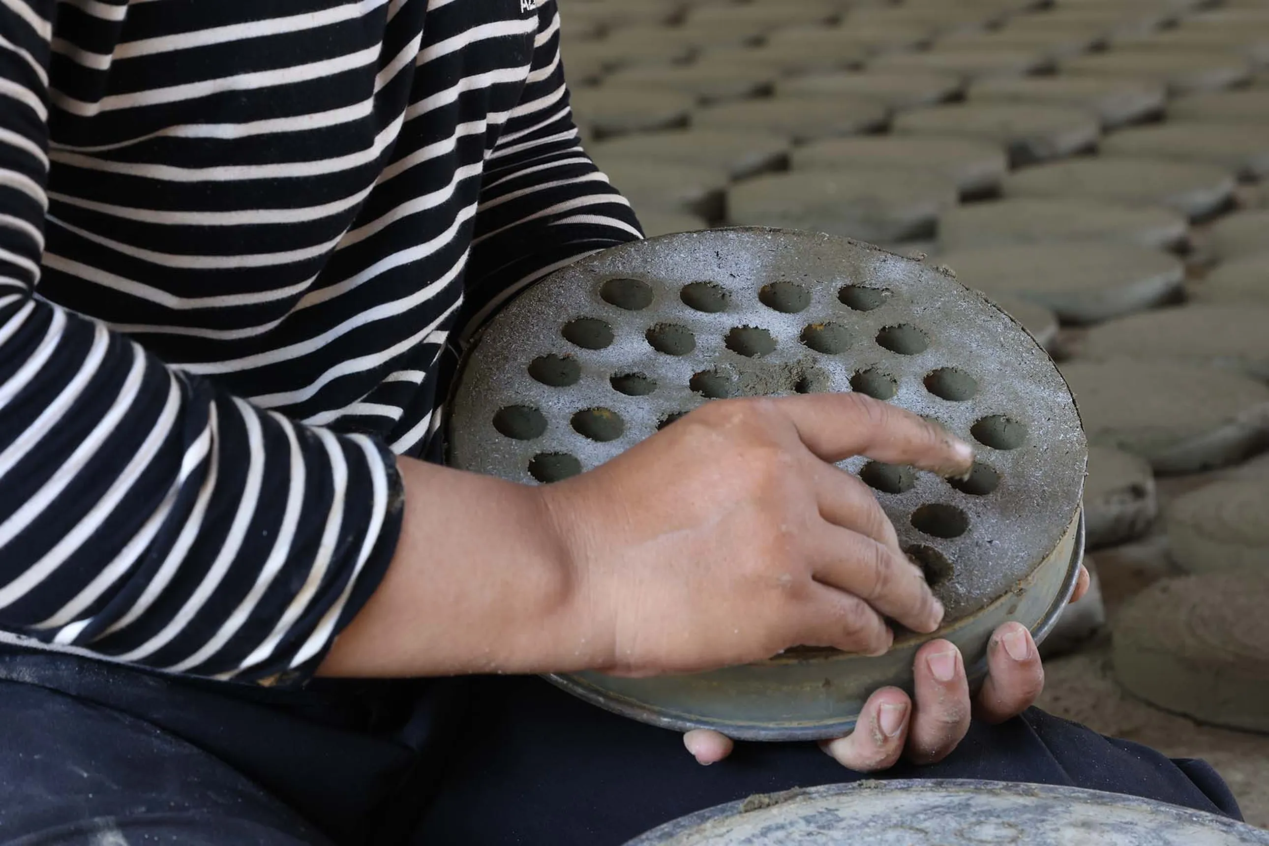 woman producing cookstoves