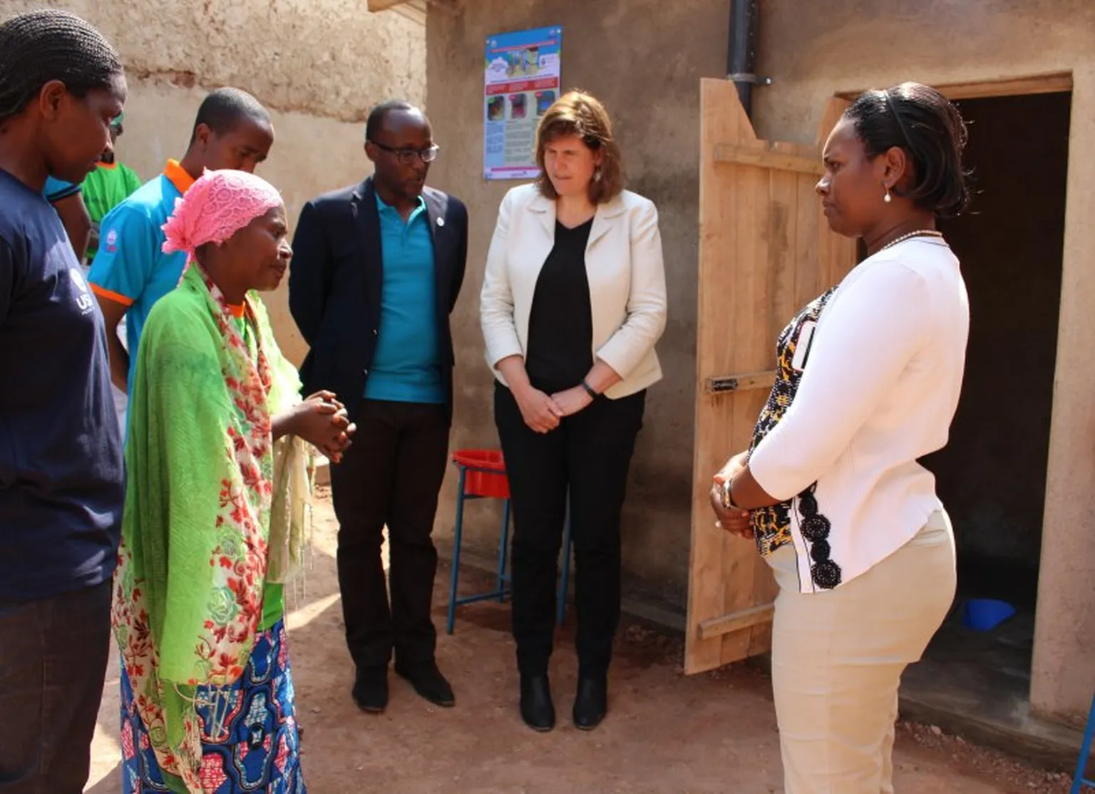 Nikuze Assouma explains the health benefits of her new latrine to the Mayor.