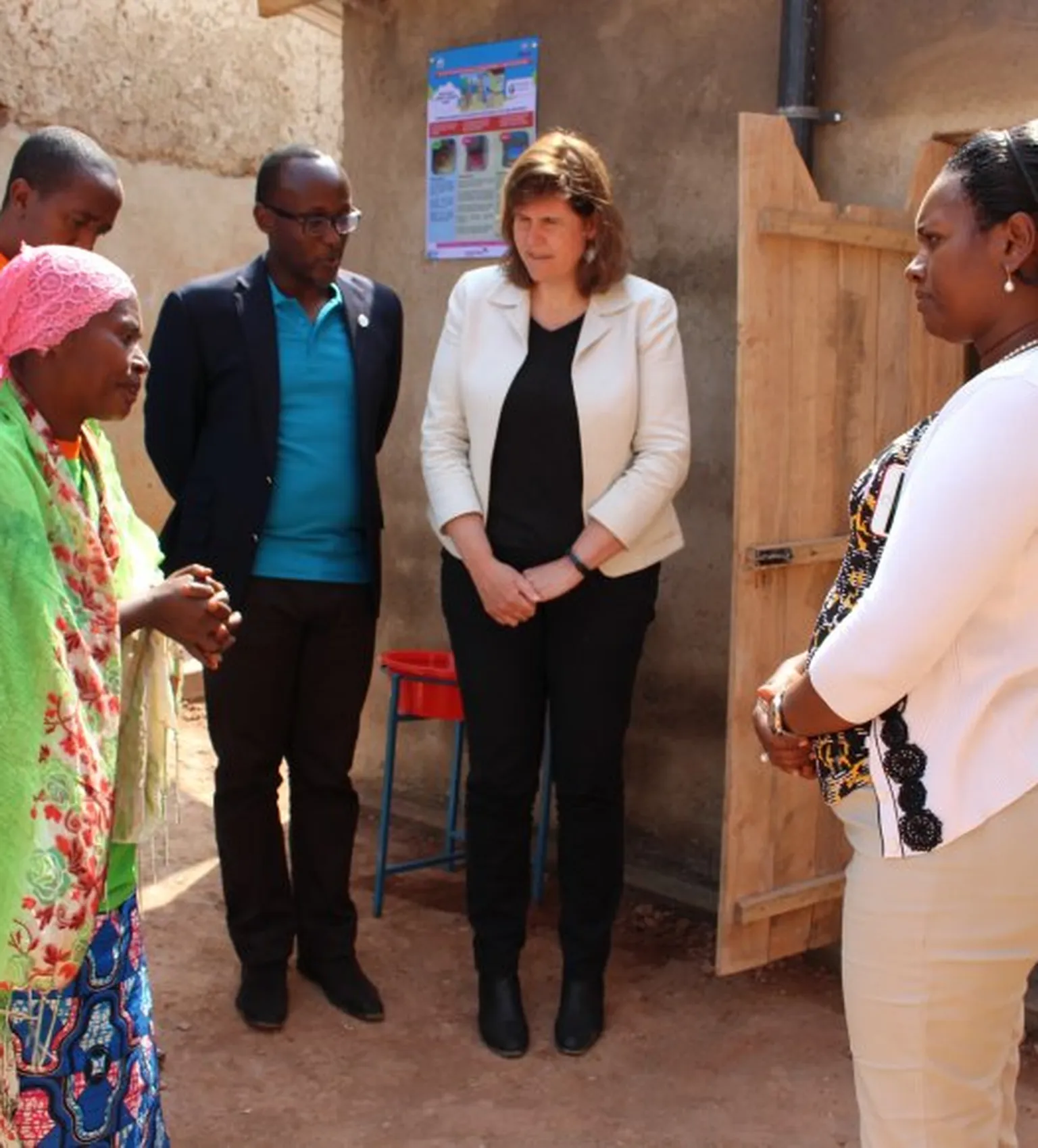 Nikuze Assouma explains the health benefits of her new latrine to the Mayor.