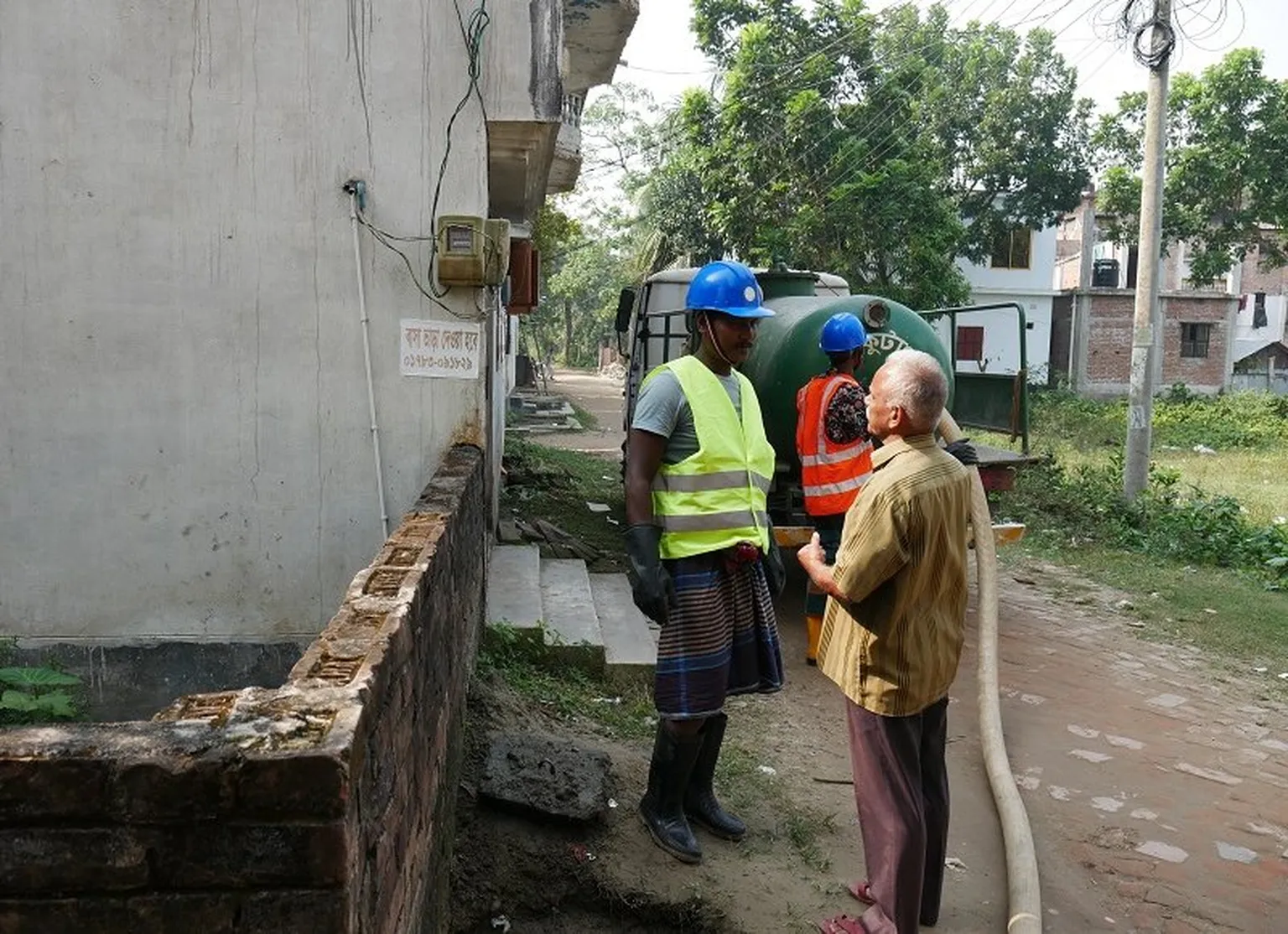 Faecal sludge service ongoing in a residential area