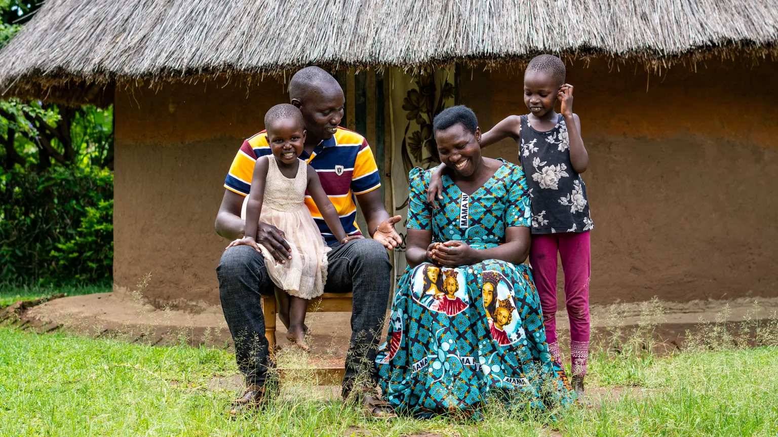 A sunflower farmer in Uganda with his family