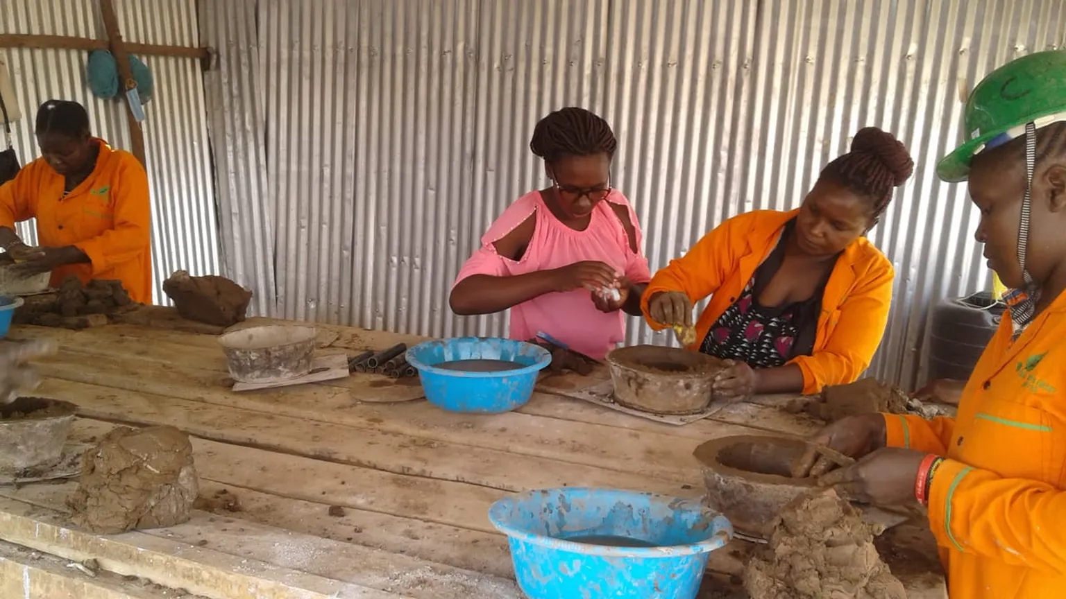 Women at Kakuma producing improved stoves 