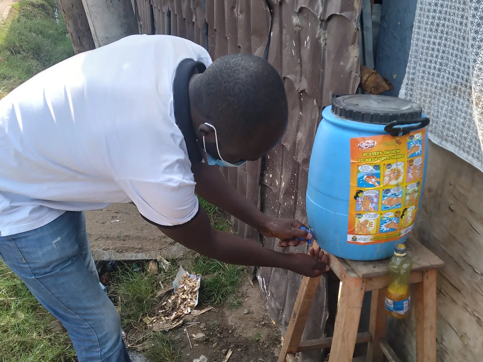 Hotel manager demonstrates the 10 steps of proper hand washing by the hotel's entrance