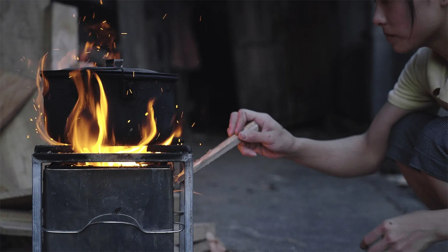 woman using a clean cookstove