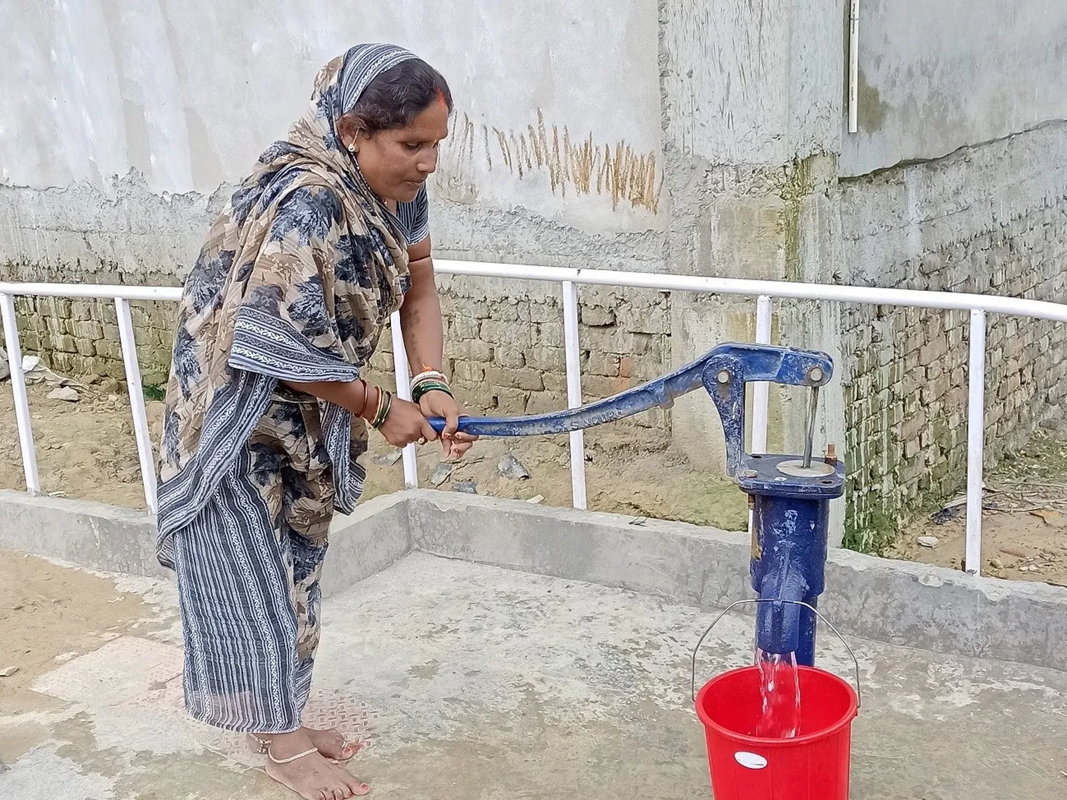 Woman with disability in upgraded waterpoint