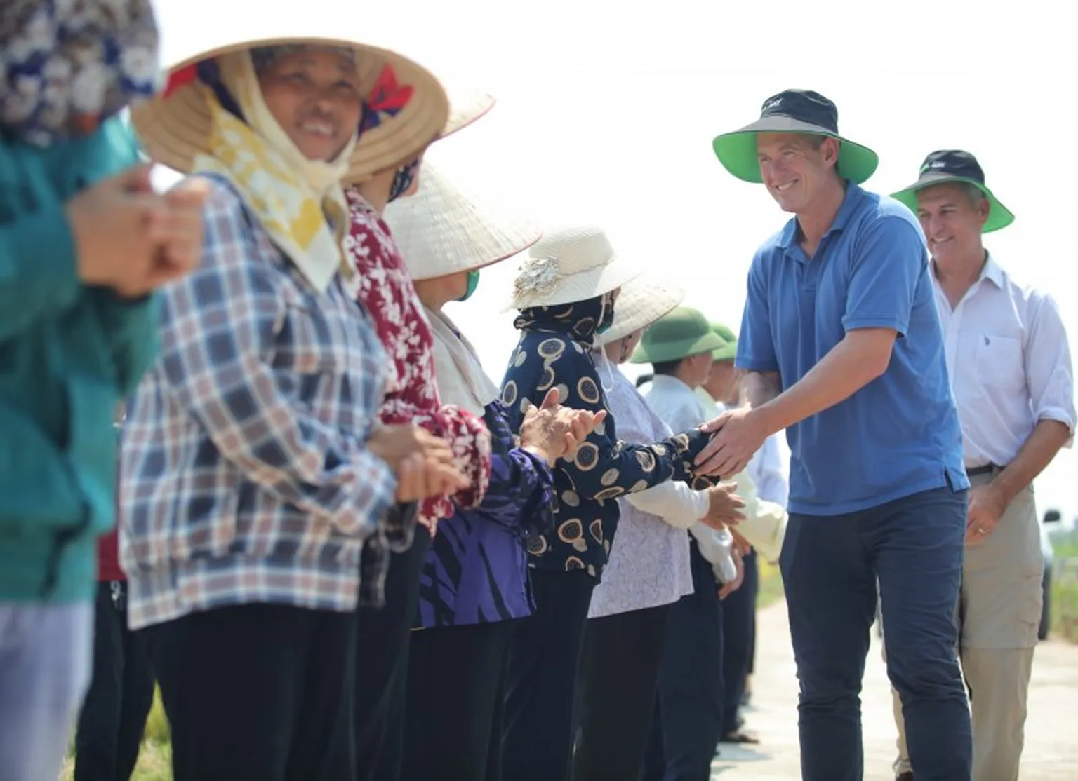 Shaking hand on a field