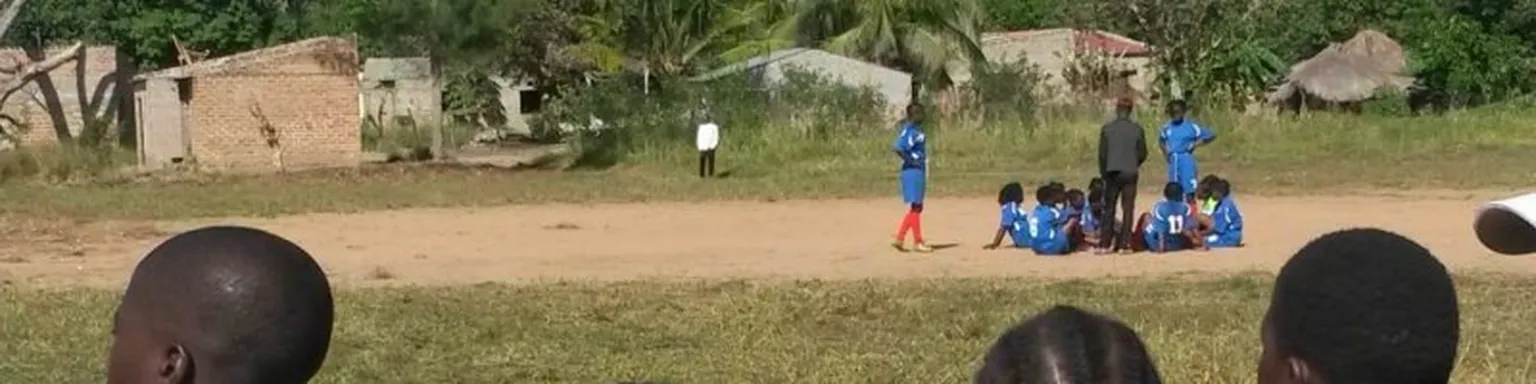 School children playing football.