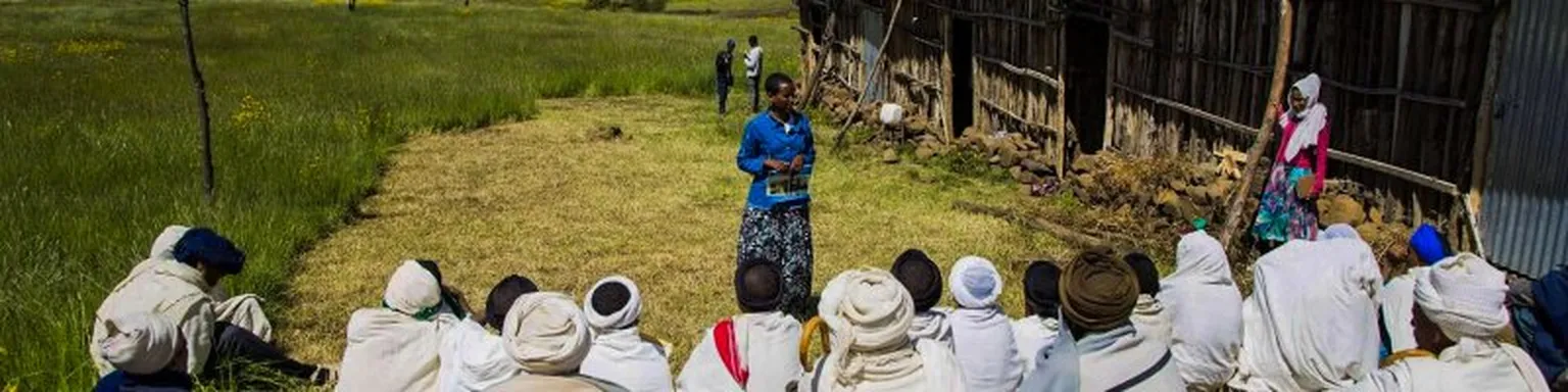 Woman teaching group of people in robes