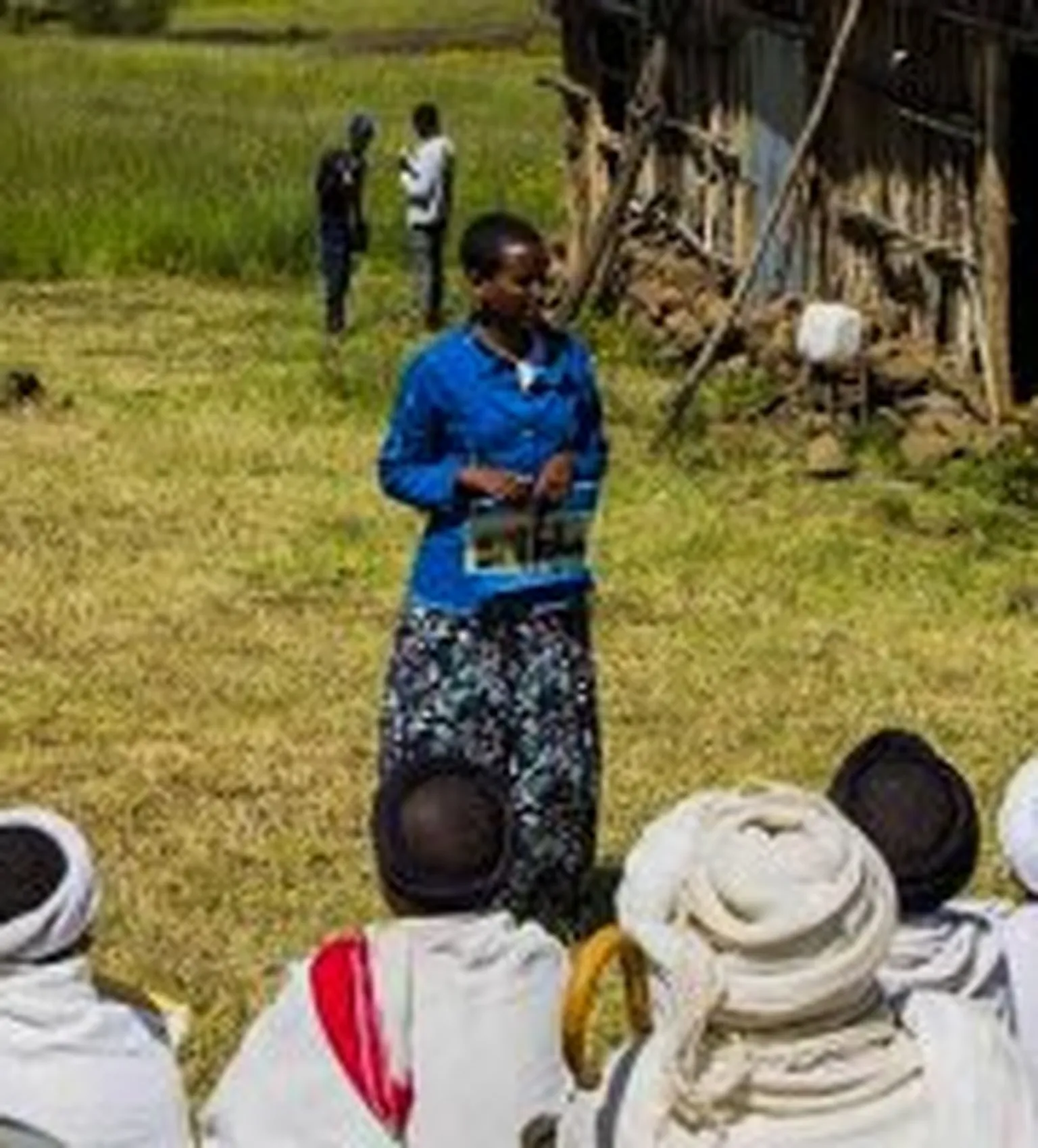 Woman teaching group of people in robes