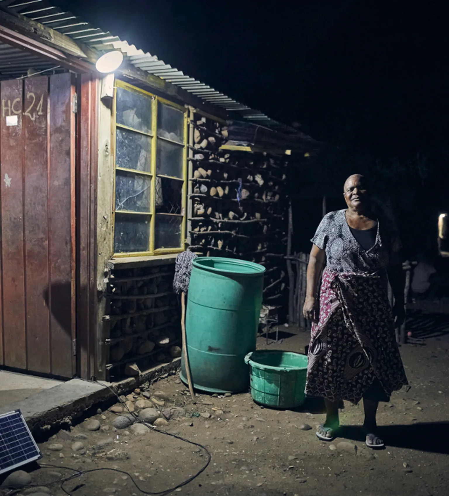 Woman standing outside her solar home 