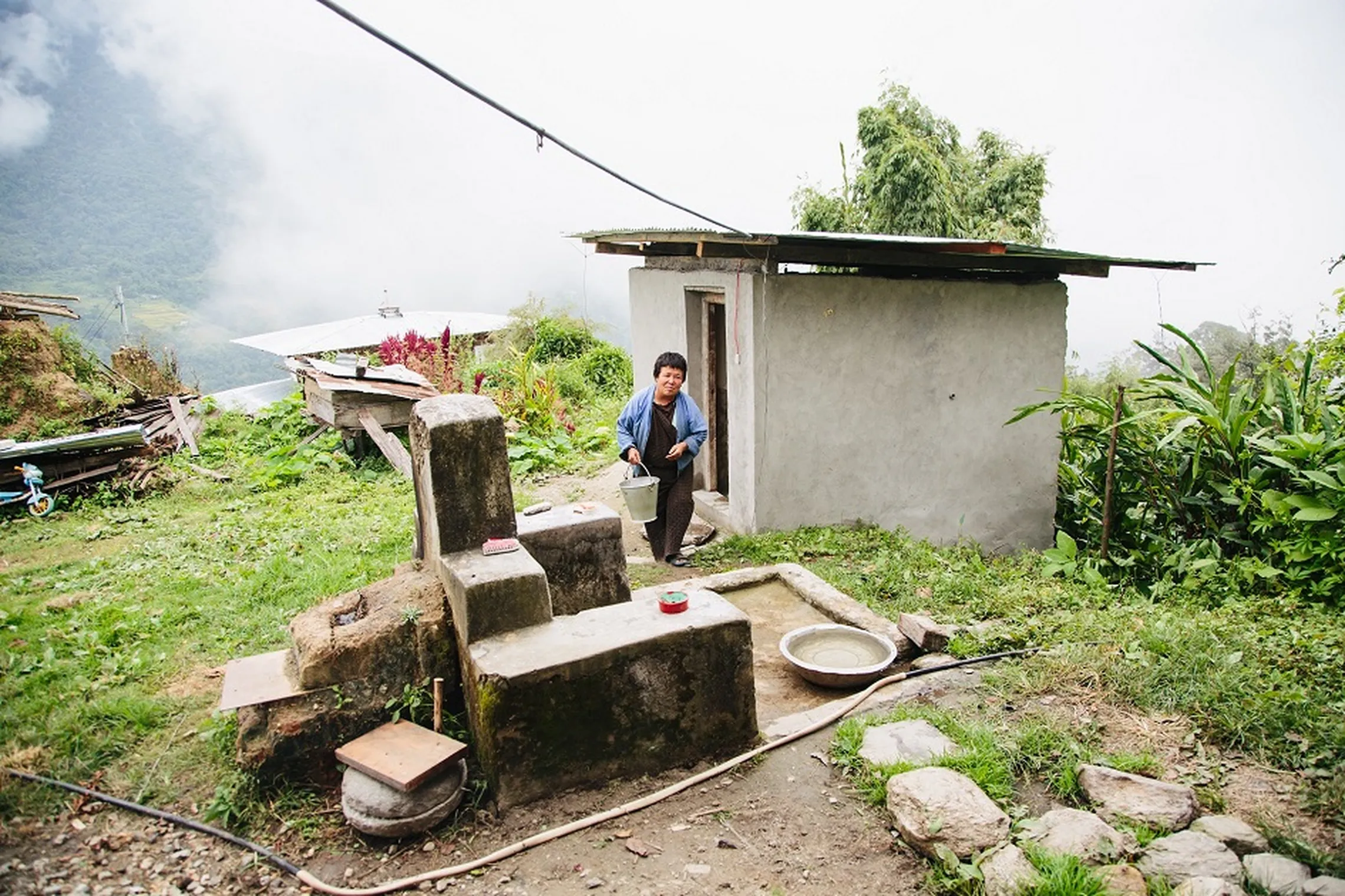 Drawing water next to toilet at Dagana district (SNV/Aidan Dockery)