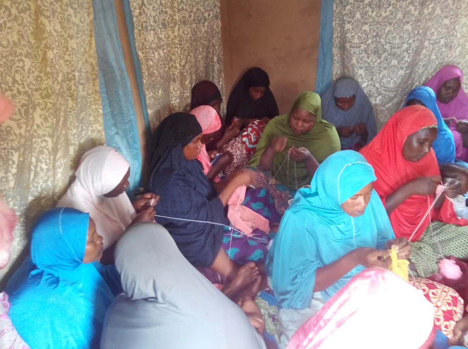 Women at Foyer Tadress learning to knit children’s clothing