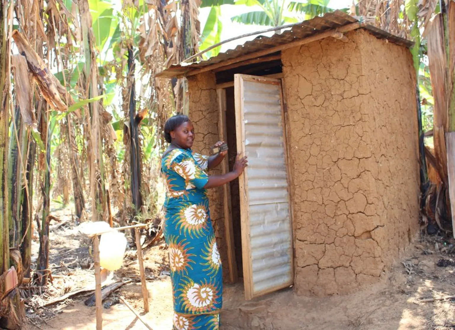 Nyiransekuye Janviere showing the various components their new household latrine