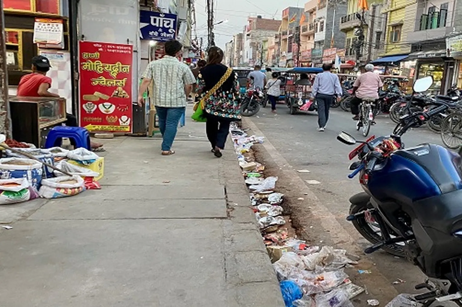 Plastic waste obstructing drainage in market's pavement system