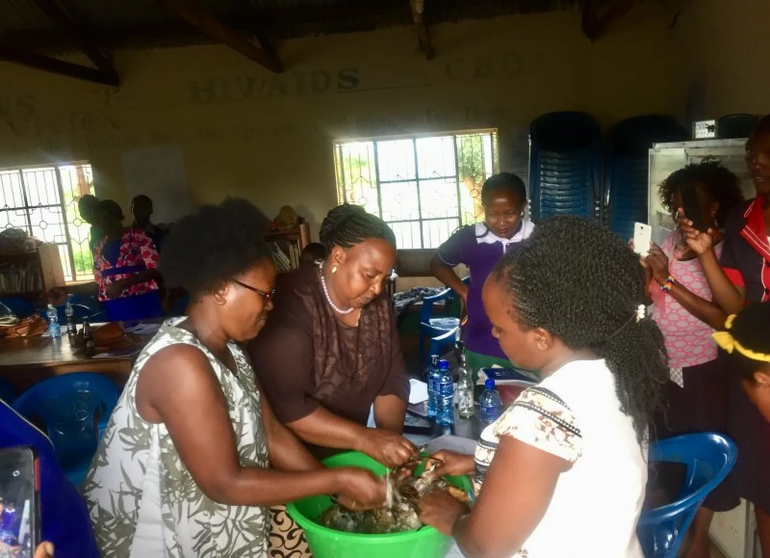 Women chicken farmers learning how to clean chicken