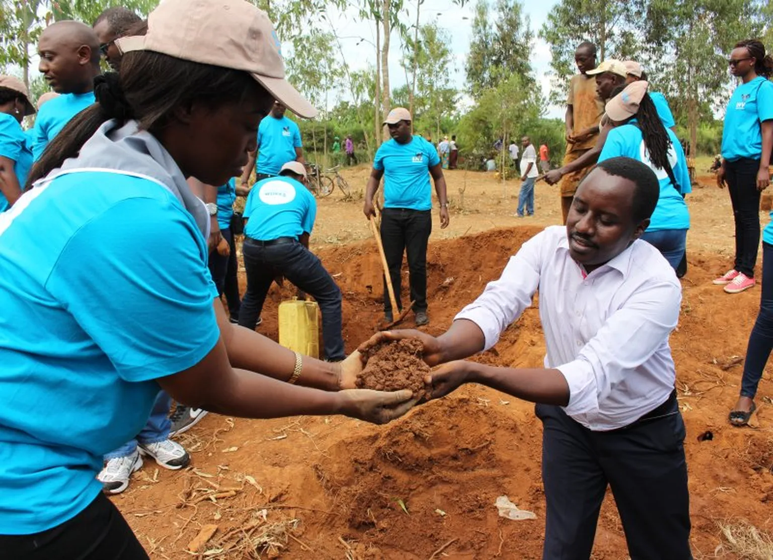 Teamwork:SNV staff and district mayor scoop mud to lay bricks to build latrines