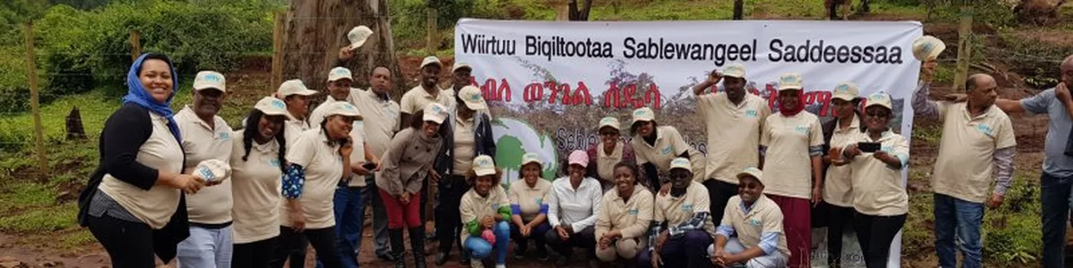 Group of people posing in front of banner