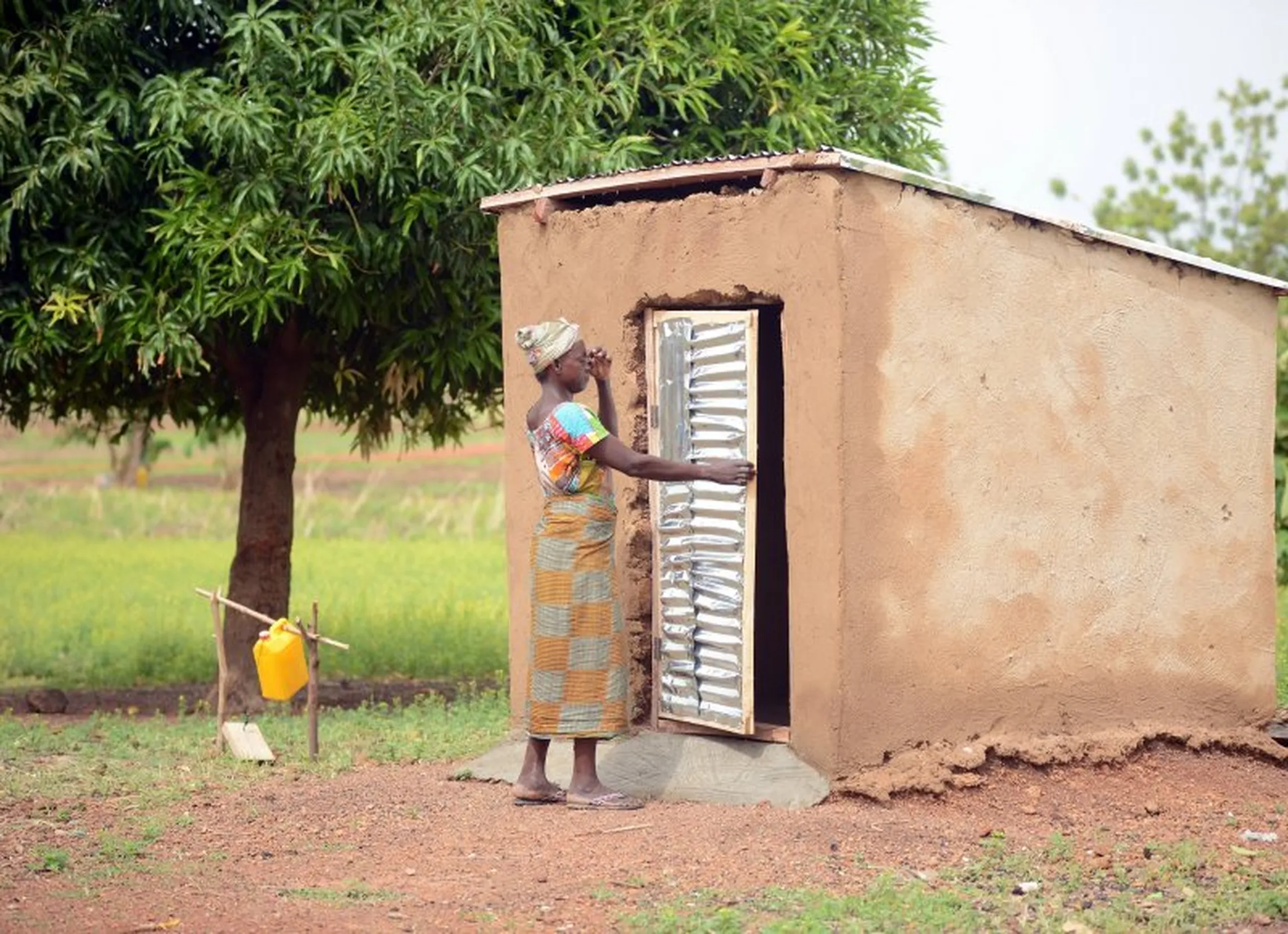 Woman opening door to hut