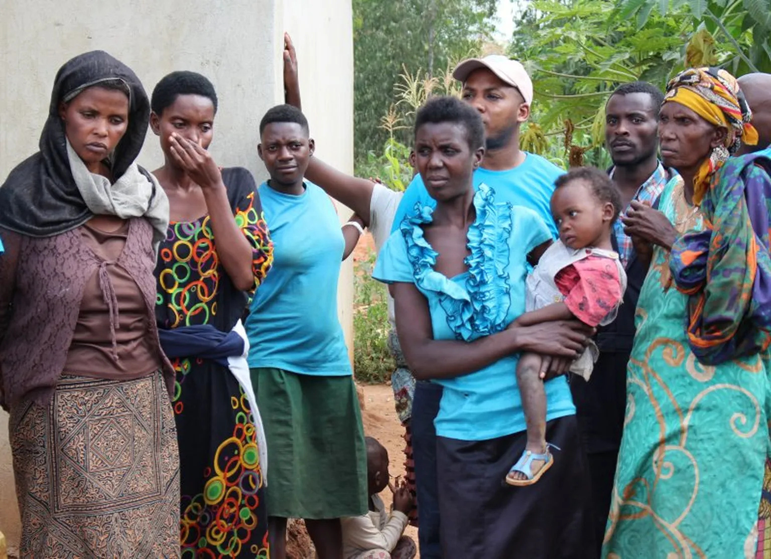 Helena Nyirasafari, (left) and fellow genocide survivors listen to speeches