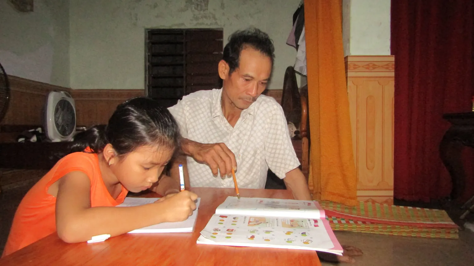 Men and women playing a game during household dialogue in Ninh Thuan