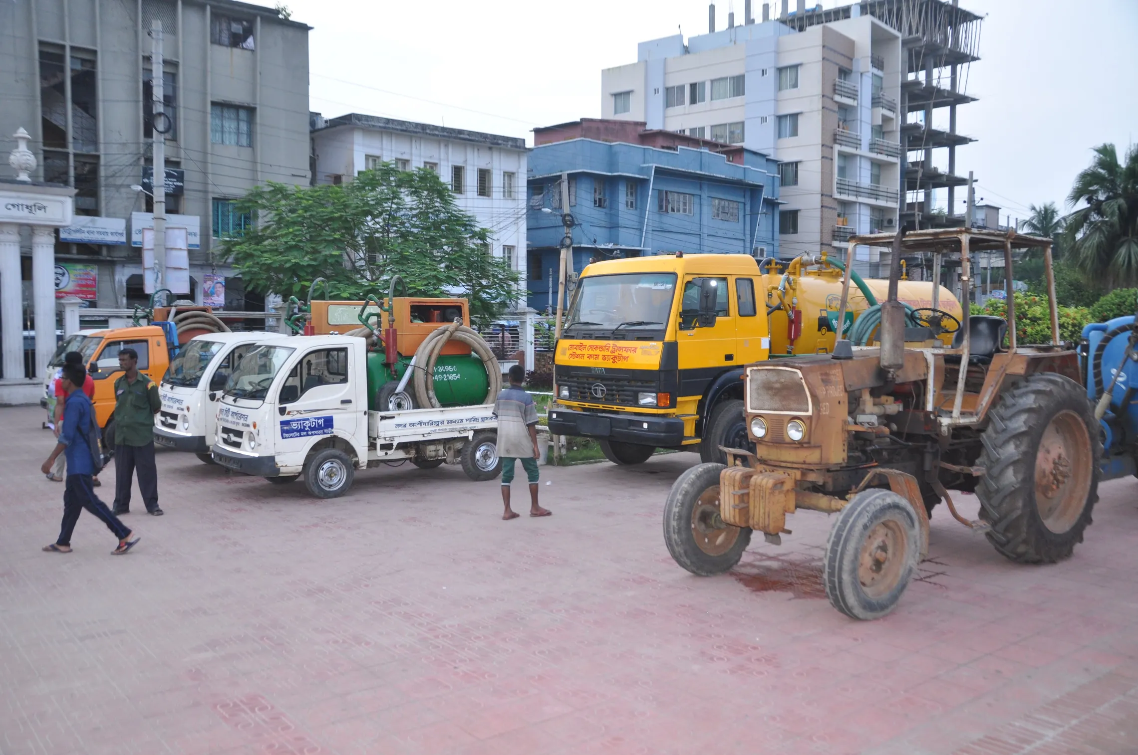 a few trucks and cars on the street