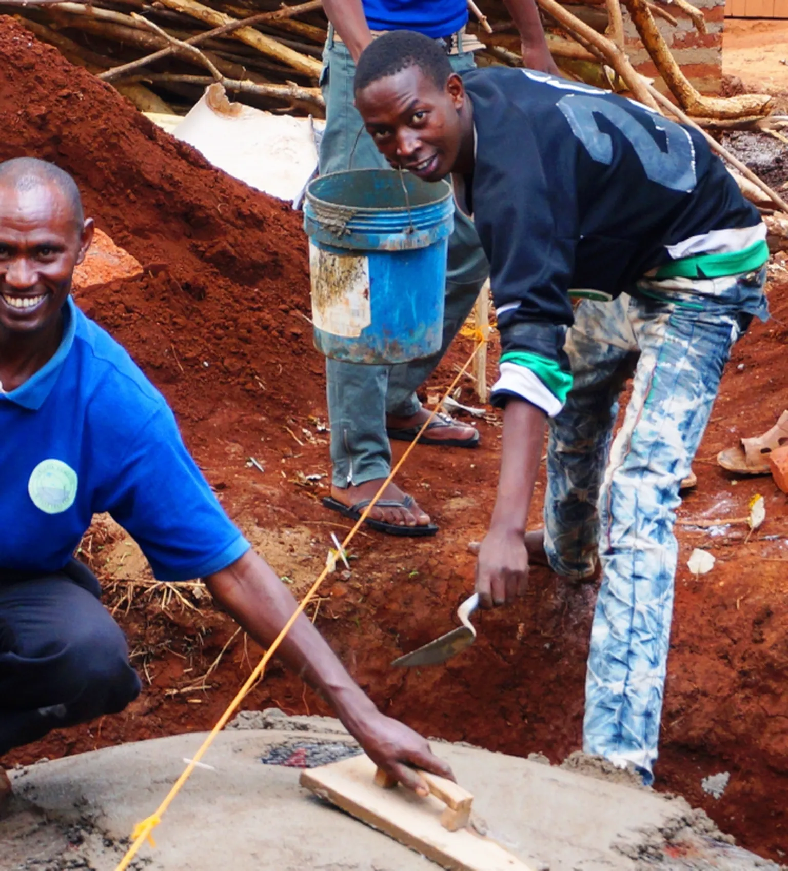 Youth building a digester 