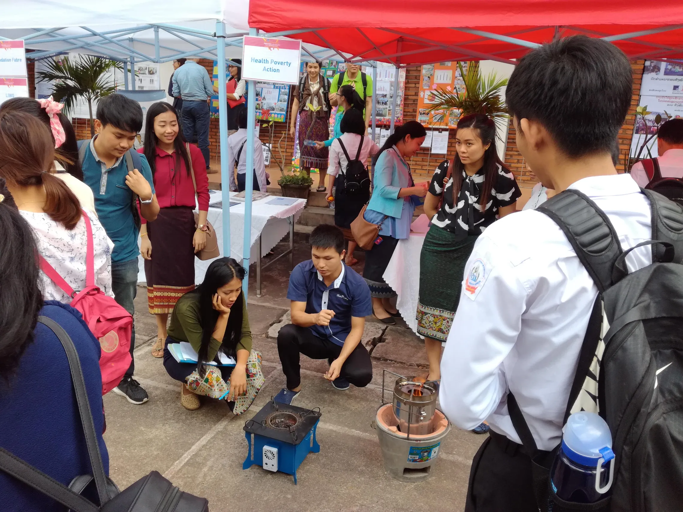 SNV Consultant Houmpheng gives cookstove demonstrations to students at the event